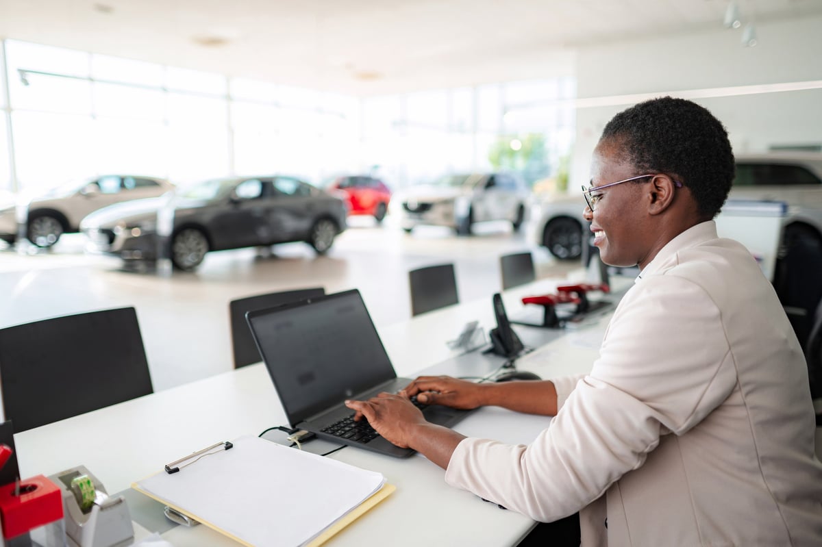 Dealership professional preparing a listing on a laptop